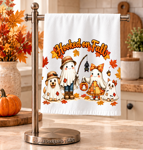 White kitchen towel displaying four ghostly Fall friends beneath Hooked on Fall lettering, surrounded by autumn leaves.